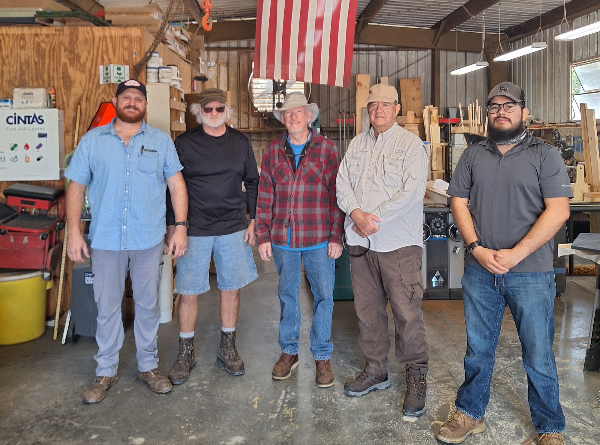 Five men stand in a shop